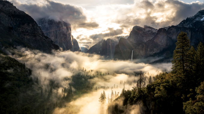 Above It All by Brandon Yoshizawa showing sunlight clouds and fog in Yosemite Valley.