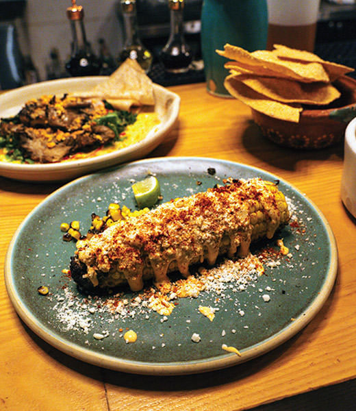 Bacanora elote, Mexican corn on the cob, served on a plate.